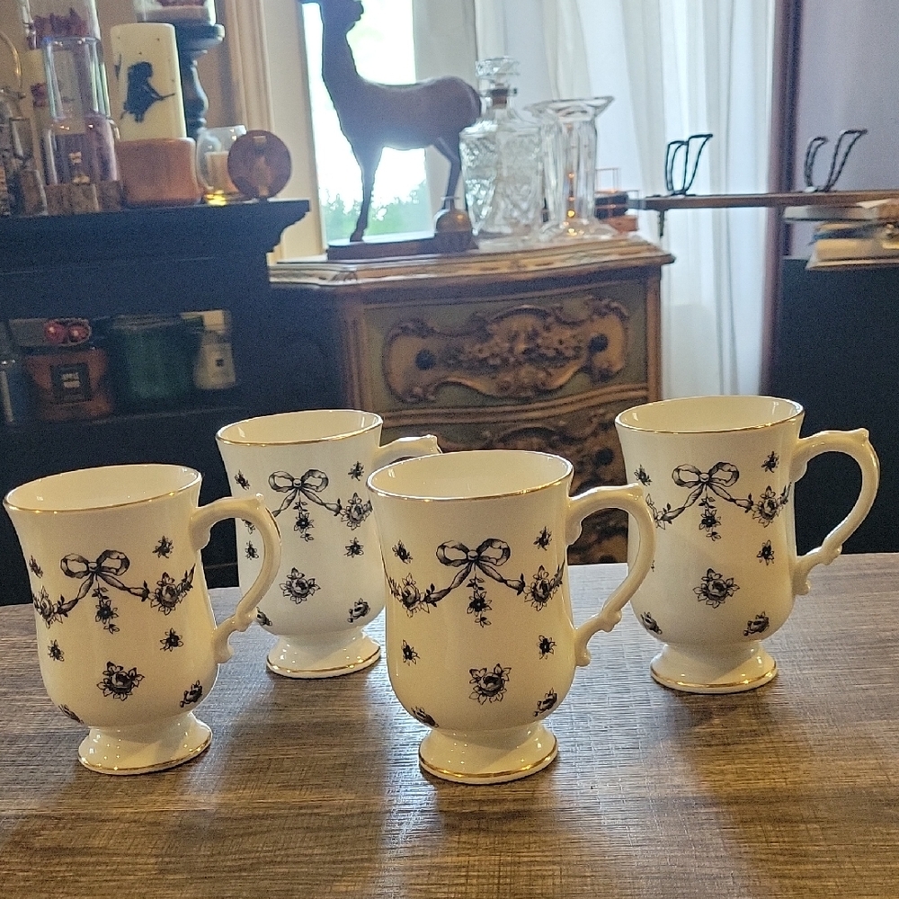 Reposhing-- Elegant White Ceramic Mugs with Black Bow Pattern - Set of 4